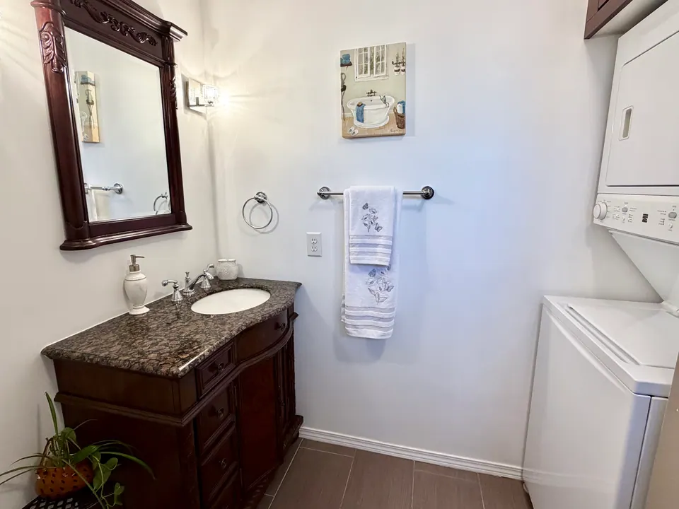 Vanity with mirror and stacked washer and dryer