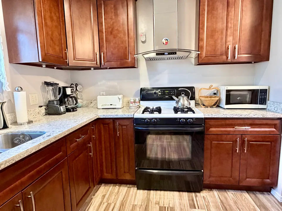 Full kitchen with range, oven, hood and microwave