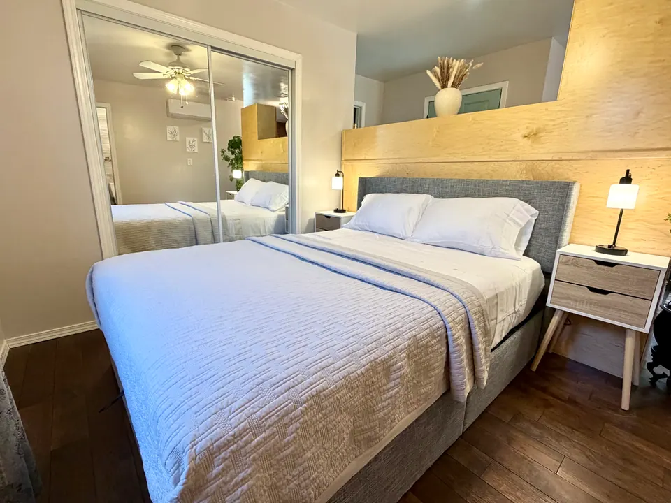 Queen memory foam bed with upholstered headboard and nightstands